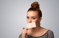 Cute girl holding white card at front of her lips with copy space Royalty Free Stock Photo