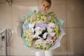 Girl holds giant bouquet of different flowers Royalty Free Stock Photo