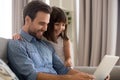 Cute girl hug dad watching video on laptop together Royalty Free Stock Photo