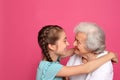 Cute girl hugging her grandmother on background Royalty Free Stock Photo