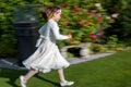 Cute girl joyous affirmation running in festive clothes for new appointed day for First Communion in autumn 2020, 6 months to late