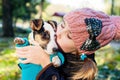 Cute girl kissing her dog in nature outdoors. Royalty Free Stock Photo