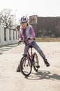 Cute girl learns to ride a bike