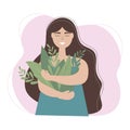 A cute girl with long hair holds a bouquet of green grass in her hands. The concept of love, care for the living planet Earth Royalty Free Stock Photo