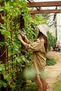 Cute girl with long hair makes cutting with large garden scissors Royalty Free Stock Photo