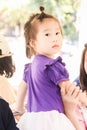 Cute girl looking backward wearing purple dress