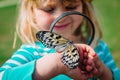 Cute girl looking at butterfy, kids learning nature Royalty Free Stock Photo