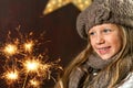 Cute girl looking at festive fire sparks. Royalty Free Stock Photo