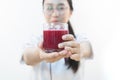 A cute girl makes vegetable juice, with carrot apple orange cranberry beetroot and mango in chef suit Royalty Free Stock Photo