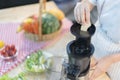 A cute girl makes vegetable juice, with carrot apple orange cranberry beetroot and mango in chef suit Royalty Free Stock Photo