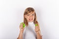 Cute girl making faces while squeezing slimes in her hands Royalty Free Stock Photo