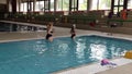 Cute girl with monofin swims in the pool