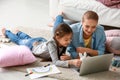 Cute girl with mother doing homework at home Royalty Free Stock Photo