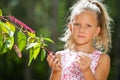 Cute girl outdoors picking berries. Royalty Free Stock Photo