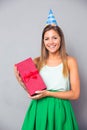 Cute girl in party hat holding gift box Royalty Free Stock Photo