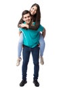 Cute girl piggyback riding on boyfriend Royalty Free Stock Photo