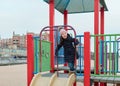 cute girl playing at a beach playground