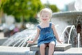 Cute girl playing with a city fountain Royalty Free Stock Photo