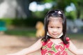 Cute girl playing in hot sun. Child sweats on forehead. Children puts mask under chin from discomfort.