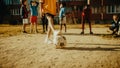 Cute Girl Playing Keepie Uppies with a Soccer Ball Together with Multiethnic Kids in the Royalty Free Stock Photo