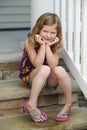 Cute Girl Playing Sitting On Porch Royalty Free Stock Photo