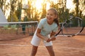 Cute little girl playing tennis on court outdoors Royalty Free Stock Photo