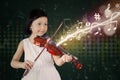 Cute girl plays violin on stage