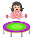 The cute girl with the pretty dress is jumping on the trampoline