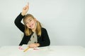 Cute girl is raising her hand in the classroom Royalty Free Stock Photo