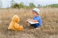 Cute girl reading book Teddy bear Royalty Free Stock Photo