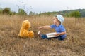 Cute girl reading book Teddy bear Royalty Free Stock Photo