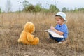 Cute girl reading book Teddy bear Royalty Free Stock Photo