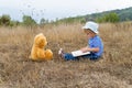 Cute girl reading book Teddy bear Royalty Free Stock Photo