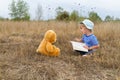 Cute girl reading book Teddy bear Royalty Free Stock Photo