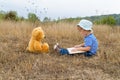 Cute girl reading book Teddy bear Royalty Free Stock Photo