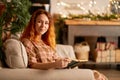 A cute girl is reading a book in a warm and cozy atmosphere. Relaxation and privacy concept Royalty Free Stock Photo