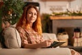 A cute girl is reading a book in a warm and cozy atmosphere. Relaxation and privacy concept Royalty Free Stock Photo