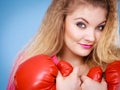 Cute girl in red gloves playing sports boxing