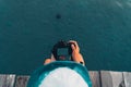 Cute girl resting and shooting on the sea Royalty Free Stock Photo