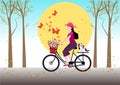 A cute girl rides a bicycle with a little dog on the back. With a bouquet of flowers in the front basket girl on bicycle Royalty Free Stock Photo