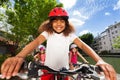 Cute girl riding bike along the river embankment Royalty Free Stock Photo