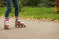 Cute girl roller skating in autumn park Royalty Free Stock Photo