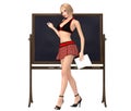 Cute girl in schoolgirl uniform stands at the blackboard with ch