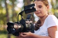 Cute girl shooting a video with a professional video camera Royalty Free Stock Photo