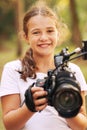 Cute girl shooting a video with a professional video camera Royalty Free Stock Photo