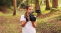 Cute girl shooting a video with a professional video camera Royalty Free Stock Photo