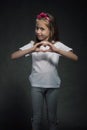 Cute girl showing heart shaped sign Royalty Free Stock Photo