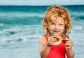 Cute girl sit with sunglasses and smile on the beach over sea Royalty Free Stock Photo