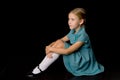 Cute girl sitting on floor hugging her knees Royalty Free Stock Photo