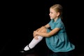 Cute girl sitting on floor hugging her knees Royalty Free Stock Photo